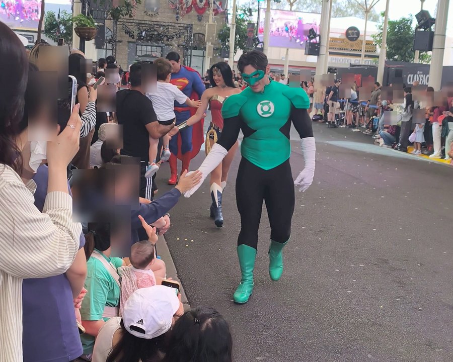 Green Lantern walking the Hero Parade at Movie World and greeting the crowd along the kerb